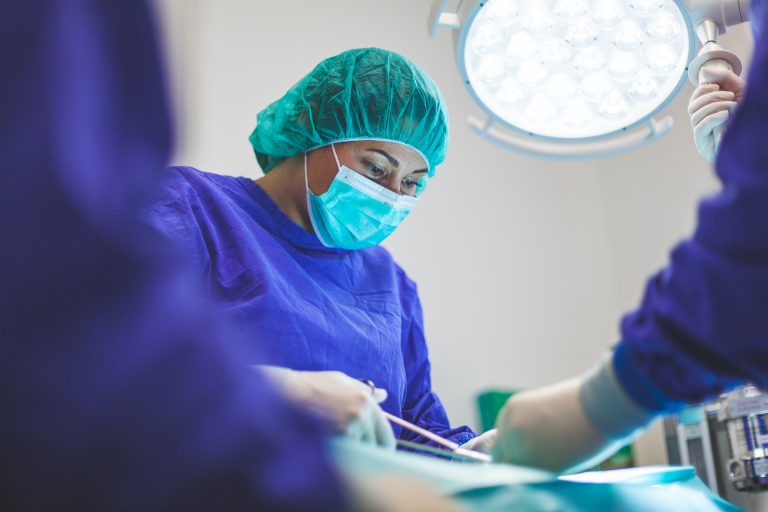 Woman surgeon performing bariatric surgery on binge eating disorder patient